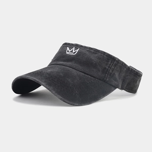Detail of black washed cotton visor with white crown embroidery and curved brim
