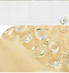 Detailed view of clear crystal pendants in various shapes with metal suncatcher hooks