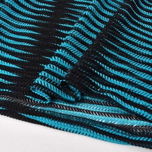 Close-up of blue and black wave pattern knit fabric with breathable mesh texture