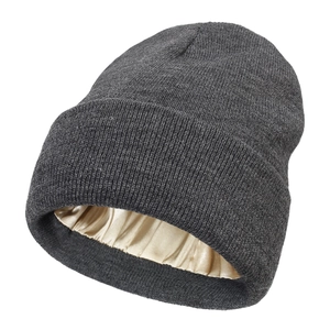 Women's warm knit beanie in dark grey with protective champagne satin lining