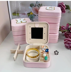 Pink travel jewelry box with mirror, cross-grain PU leather and zipper closure detail