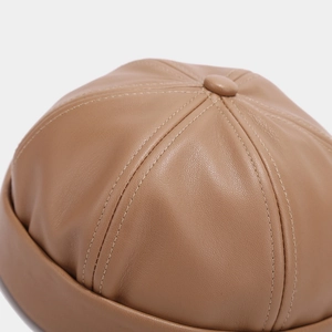 Detail of premium brown PU leather docker hat showing stitching and texture