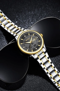Detailed macro shot of the black dial with diamonds, date display, and steel watch band