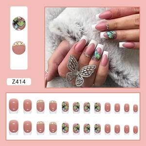 French tip press-on nails with butterfly hand-painting and pearl rhinestone accents