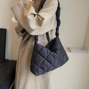 Black quilted cloud puffy shoulder bag with large capacity worn with beige trench coat