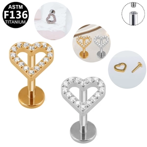 Detail of heart-shaped G23 titanium labret studs with zircon inlays and screw threads