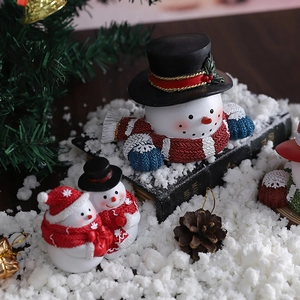 Christmas snowman resin figurines set with red scarves and hats on winter background