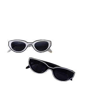 Vintage Y2K cat-eye sunglasses with contrasting black and white frames and dark lenses