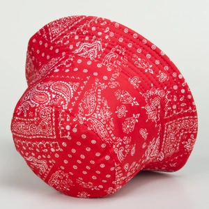 Detail view of red paisley cotton bucket hat with white pattern and stitched brim