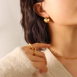 Polished 18K gold plated stainless steel C-shaped chunky earrings on a female model