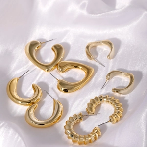 Elegant gold geometric earrings set featuring heart hoops and spiral textured studs