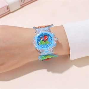 Close-up of kids dinosaur watch with light blue silicone strap and 3D cartoon patterns