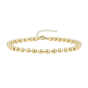 Macro shot of gold beaded bracelet featuring a lobster clasp and adjustable extension chain