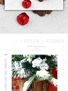 Close-up of a red Christmas bell with snowy pine branch on a natural rustic wood base