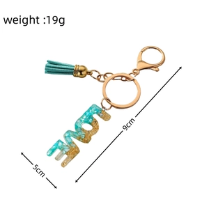 Detailed view of rainbow resin LOVE keychain with dimensions 9cm length and 19g weight