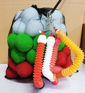Close-up of colorful pop tubes toy set with mesh bag of plastic snowballs for kids
