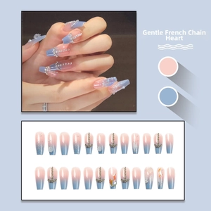 Detail of long coffin press-on nails with blue-pink gradient and crystal heart decor
