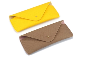 Close-up of snakeskin texture leather sunglasses cases with gold button closure