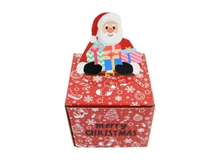 Detail of red Christmas corrugated gift box with Santa Claus cutout and snowflake patterns