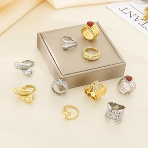 Close-up of 18K gold and silver plated knot rings with crystal water drop accents