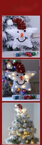 Macro view of glowing LED snowman star tree topper with red sequin hat and warm light