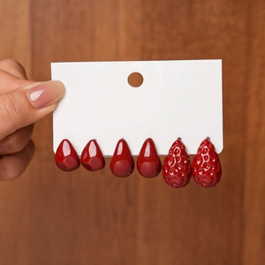 Close-up of six-piece vintage red acrylic water drop earrings on display card