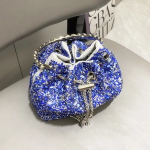 Close-up of blue crystal evening bucket bag with metal ring handle and chain strap