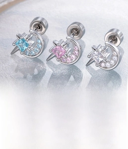 Detail of silver star and moon cartilage studs with zircon inlay and sizing specs
