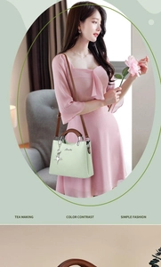 Close-up of light green crossbody bag with brown handle and metal charm on a pink dress