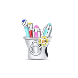 Macro shot of silver painter's palette charm with colorful enamel flowers and gems