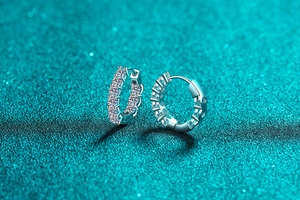 Detailed macro view of S925 sterling silver hoop earrings with paved moissanite stones