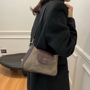 Retro brown contrast color hobo bag with textured flap and adjustable shoulder strap