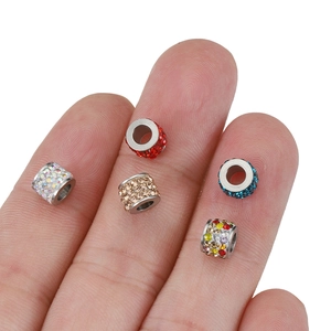Five colorful sparkling rhinestone beads on fingers showing high-quality DIY jewelry detail