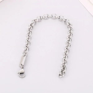 Detail of silver stainless steel curb chain bracelet with blank engravable metal tag