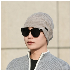 Detail of khaki cable-knit visor beanie with soft fleece lining for autumn and winter
