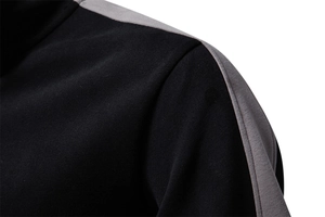Detail shot of the shoulder seam on a black and grey拼接 sports sweatshirt for men