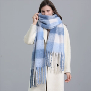 Thick blue and white plaid mohair scarf with fringes worn with a beige coat