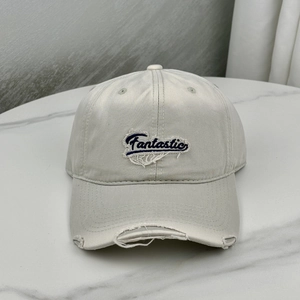 Detail of Fantastic embroidery and distressed ripped effects on cotton baseball cap
