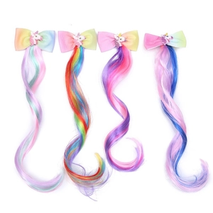 Set of four unicorn rainbow colored hair extensions with cute bow clips for children