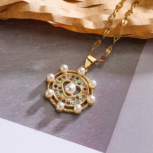Golden necklace with rudder pendant featuring pearls, colored zircons and a heart cutout