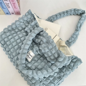 Detail of blue bubble textured tote bag with soft fabric and spacious inner lining