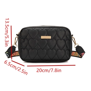 Detailed size guide of black heart-quilted crossbody bag with dimensions and wide strap
