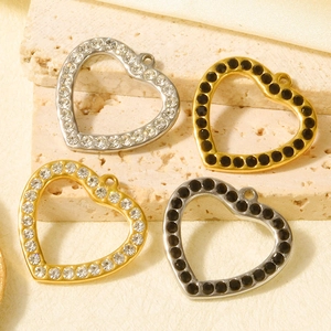 Detail of 304 stainless steel heart pendants with crystal and black stone inlays