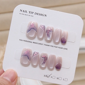 Detail of purple mermaid cat eye handmade press-on nails in size XS on display card