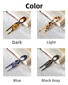 Detailed view of four acetate U-shaped hair pins with vintage tortoise patterns