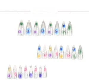 Detail of long stiletto press-on nails featuring colorful ombre and silver flame motifs