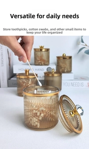 Close-up of amber ribbed glass storage jars with gold rims and decorative lids for home