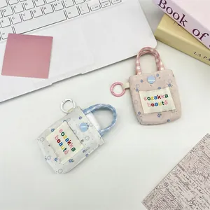 Detailed close-up of floral fabric mini pouches with rainbow woven labels and button closure