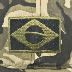 Macro detail of camouflage tactical cap with embroidered Brazil flag patch texture