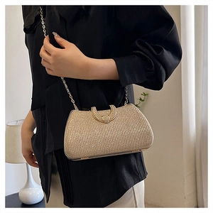 Close-up of sparkling gold evening bag with a metallic chain strap and stylish clasp